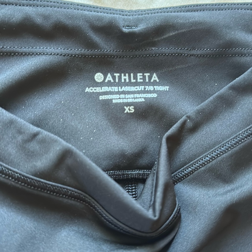 Athleta Lasercut 7/8 tights with Reflective Accents and back zipper pocket NWOT